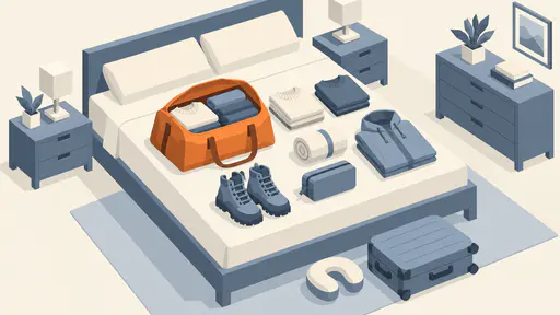 An open duffel bag packed with folded sweaters sits on a bed beside a rolled towel, boots, a toiletry pouch, a raincoat and a suitcase in isometric vector style.