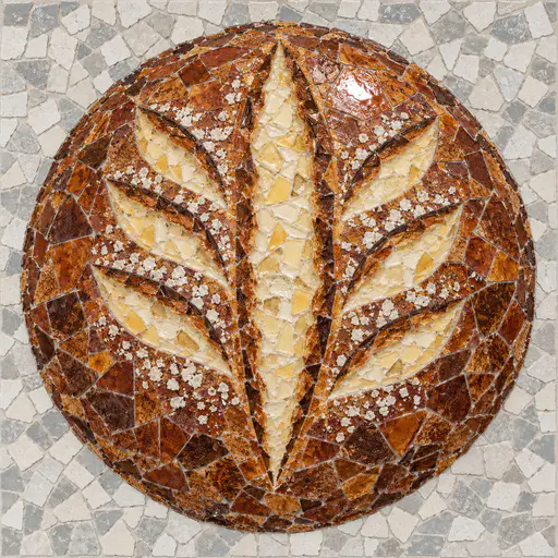 A mosaic of irregular glazed-tile shards showing a round sourdough loaf from above, its chestnut crust split along a central cut and curved side cuts into cream crumb, flecks of flour and a bright glaze highlight on a grey and white tile ground.
