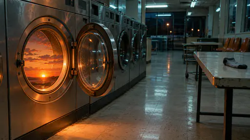 An empty late evening laundromat has a tiny orange and pink sunset glowing inside the open drum of a front loading washer under mint fluorescent tubes, photographed on colour film.