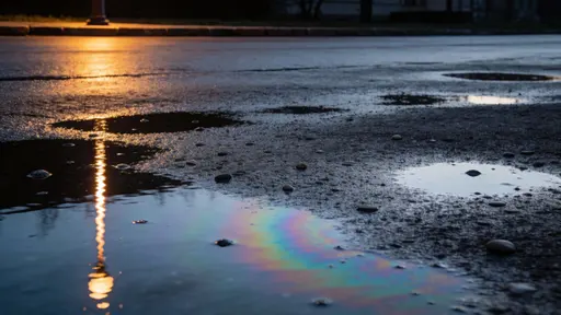 Nighttime wet asphalt reflecting a street light, composed as a 16:9 wide urban scene photographed for wallpaper with moody cinematic lighting and reflective textures.